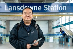 Travel training manager Chris Chan stands outside Lansdowne Station