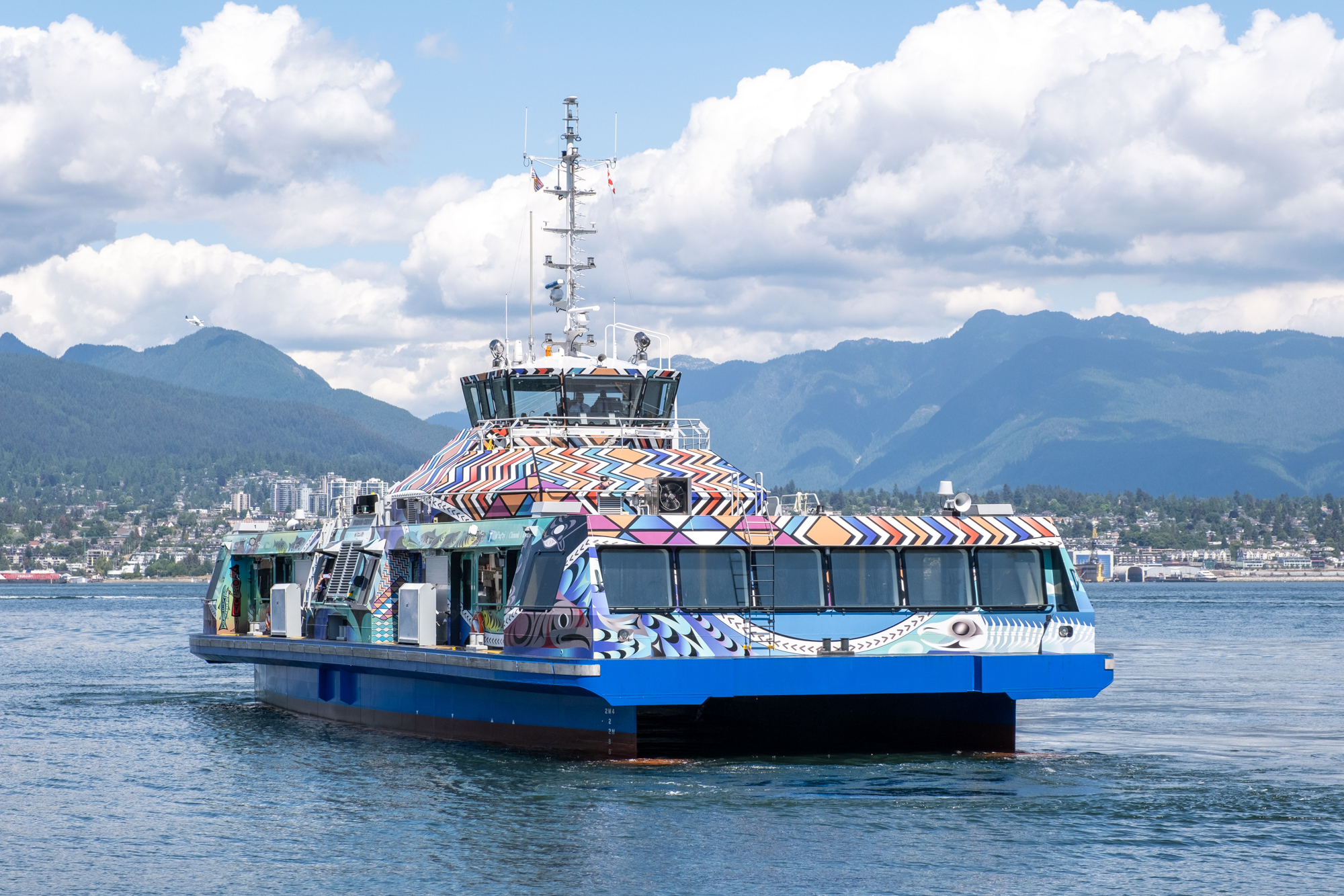 The colourful artwork of the Burrard Chinook as the vessel sails in the water