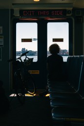 A woman and her bike wait for the Burrard Chinook SeaBus to sail