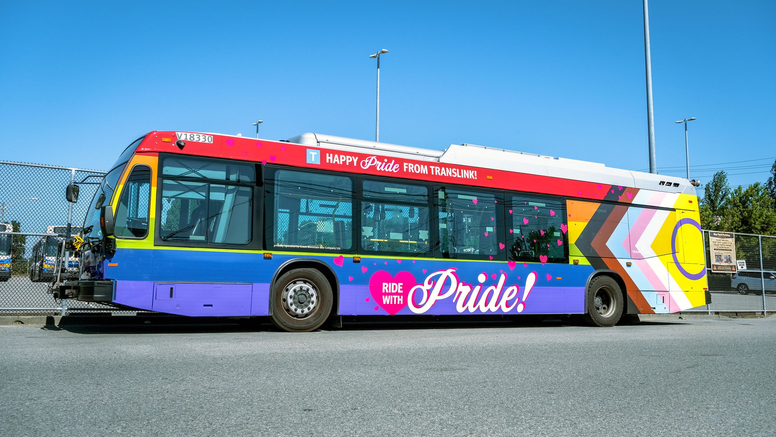 Side view of the rainbow-wrapped 2022 PrideBus