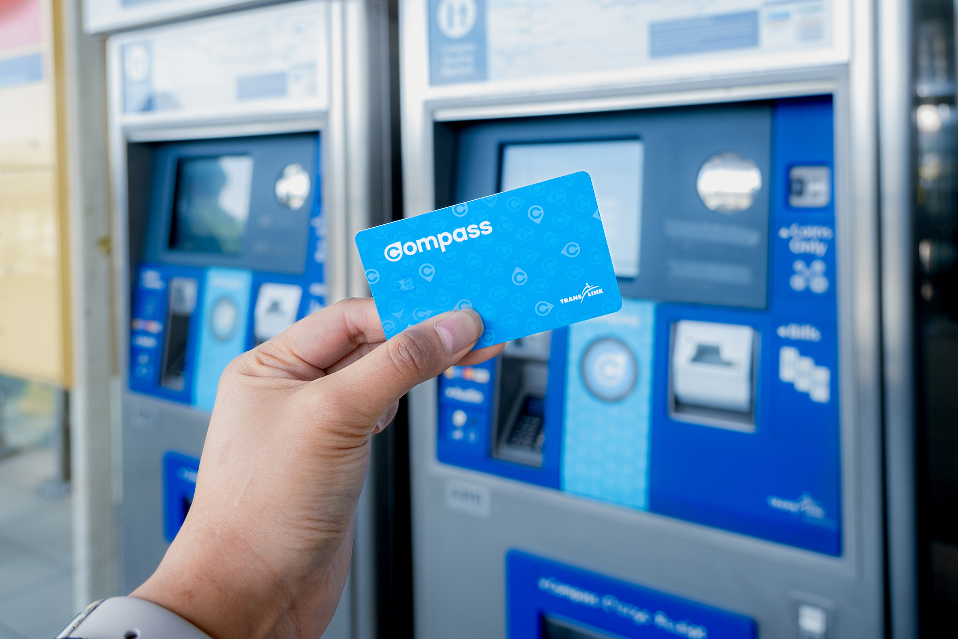 Compass Card in front of two Compass Vending Machines