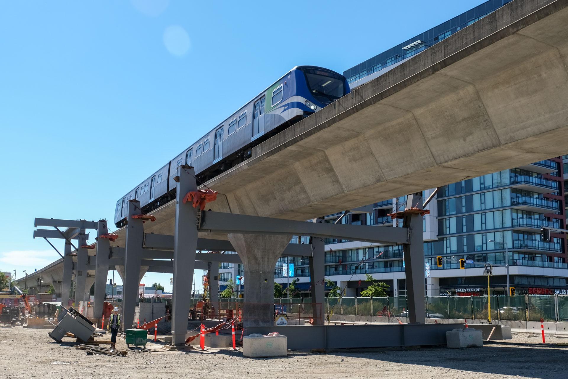 The SkyTrain passes by the under construction Capstan Station