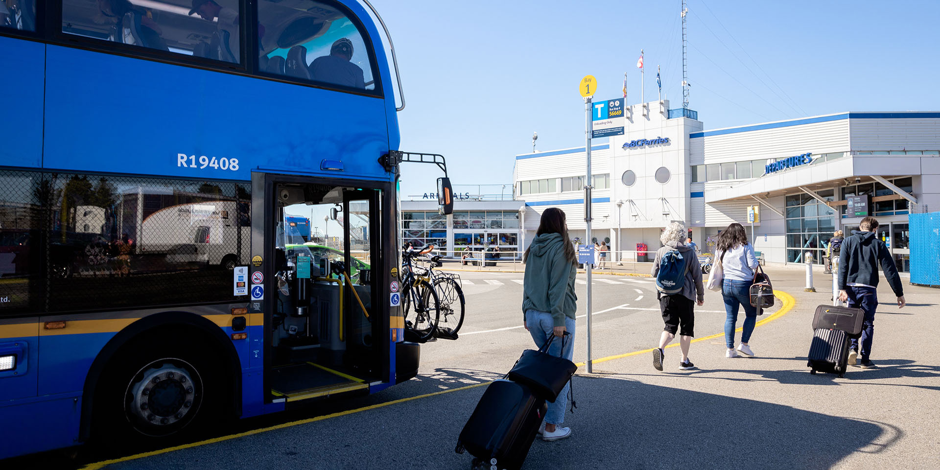Customers disembark from the 620 bus and head towards Departures at the Tsawwassen Ferry Terminal