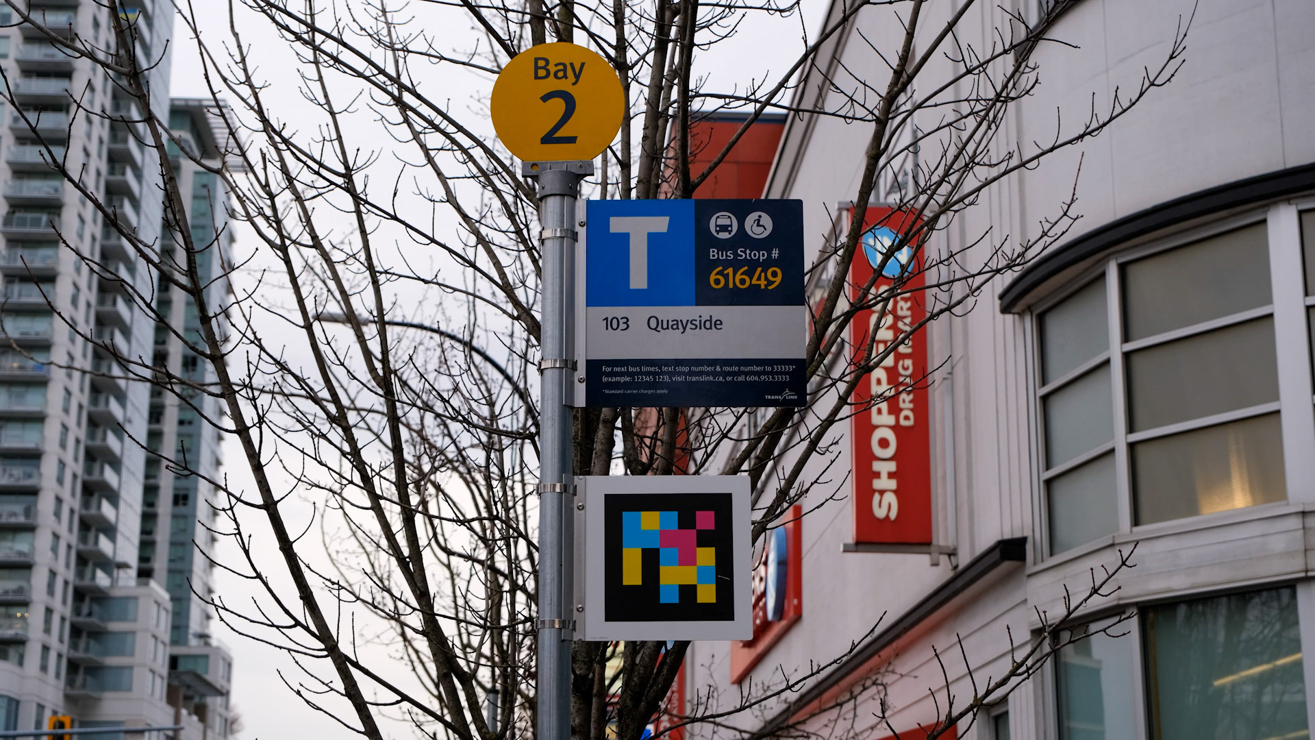 TransLink Accessible Navigation Project NaviLens coded decal at bus stop.