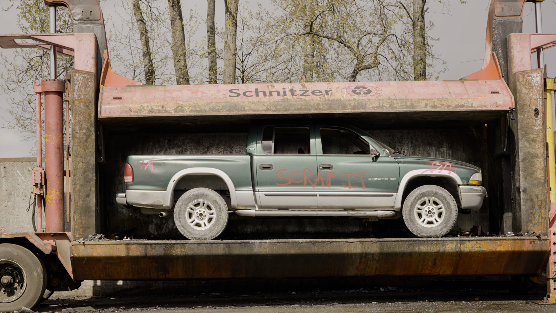 A scrapped vehicle being crushed at a Scrap-it Yard