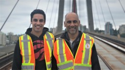 Father-son duo Michael and Keith Edema pose for a photo on the SkyBridge