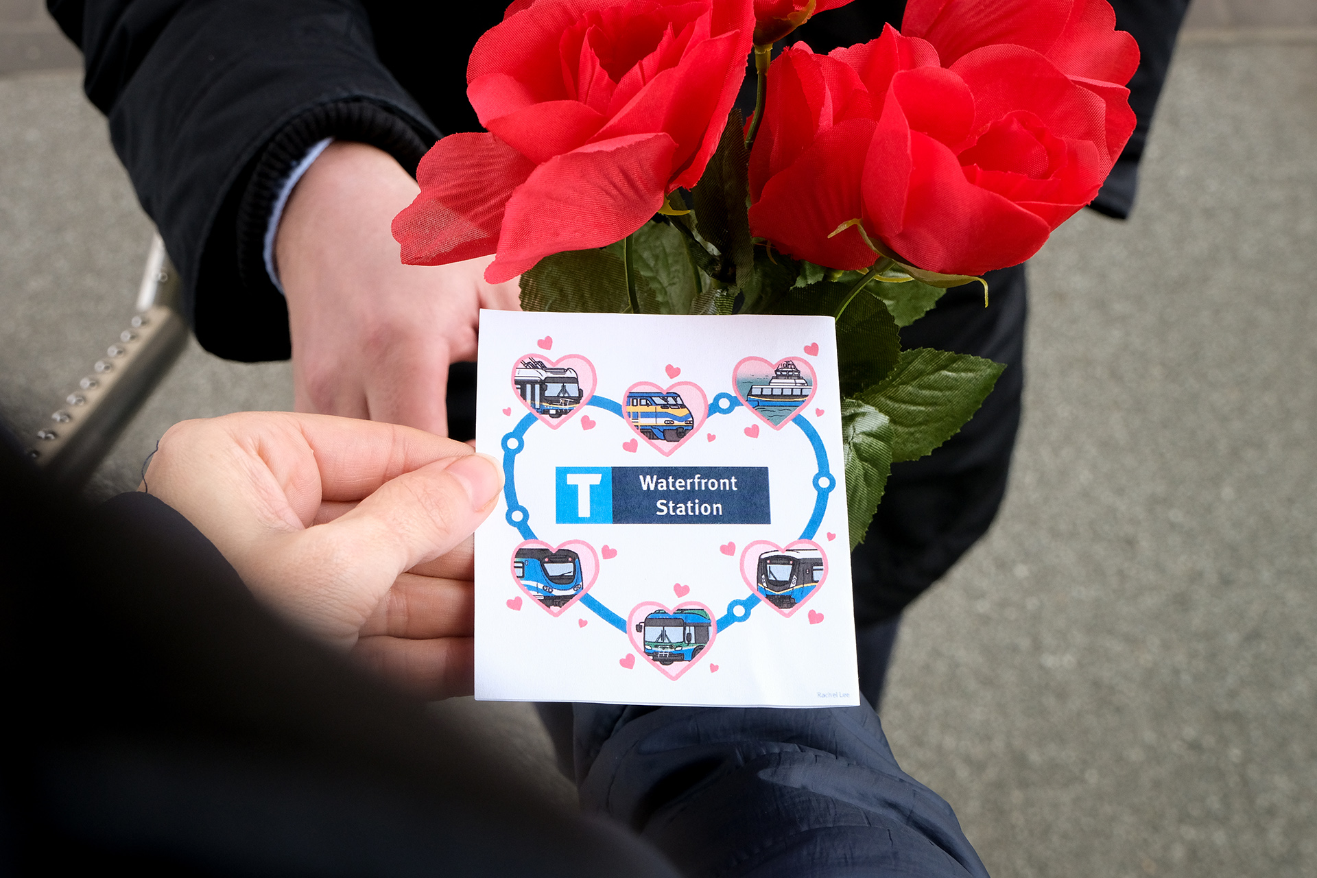 Person hands TransLink Valentines Day Card to someone