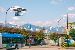 An eVTOL vehicle taking off at Olympic Village