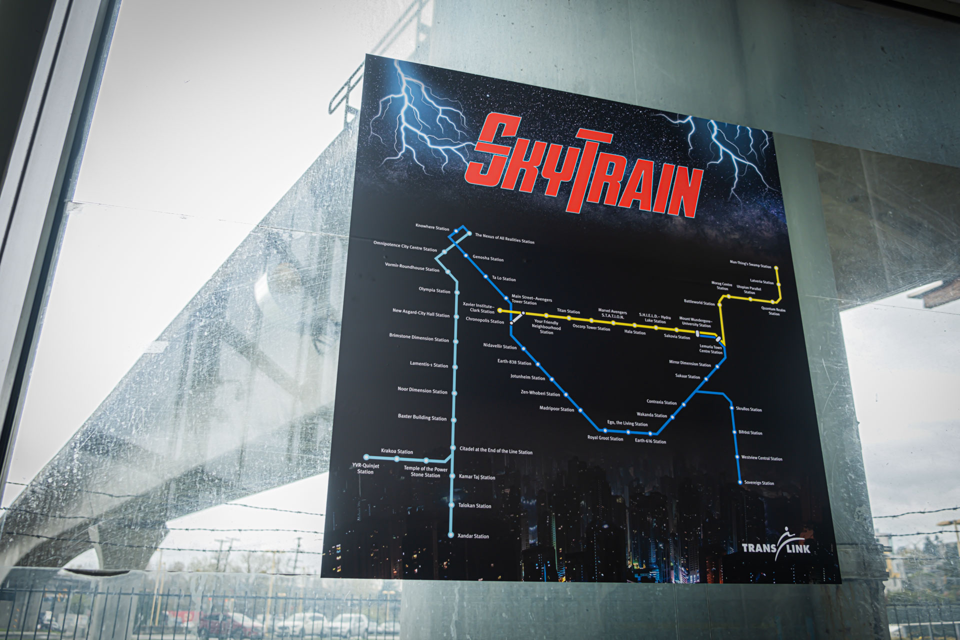 The Avengers SkyTrain map at Braid Station with the guideway in the background
