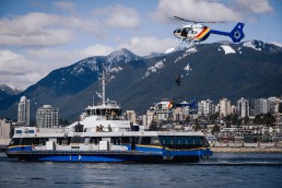 Helicopters fly above the SeaBus during a security exercise.
