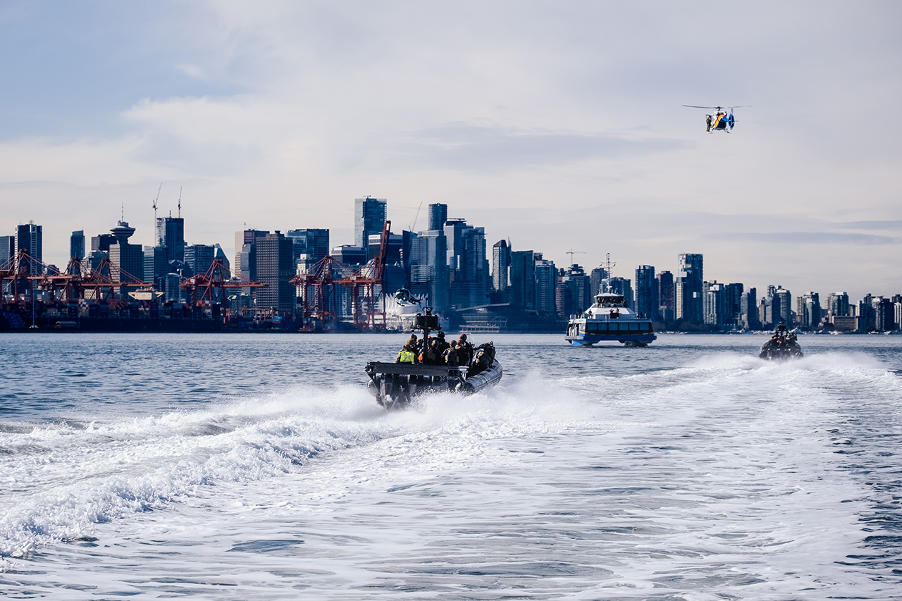 Two high-speed crafts and a helicopter approach the SeaBus.