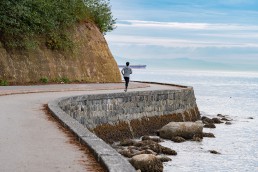 A person running along the seawall in Vancouver's Stanley Park
