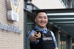 Transit Police Community Safety Officer David Shin holds up his badge