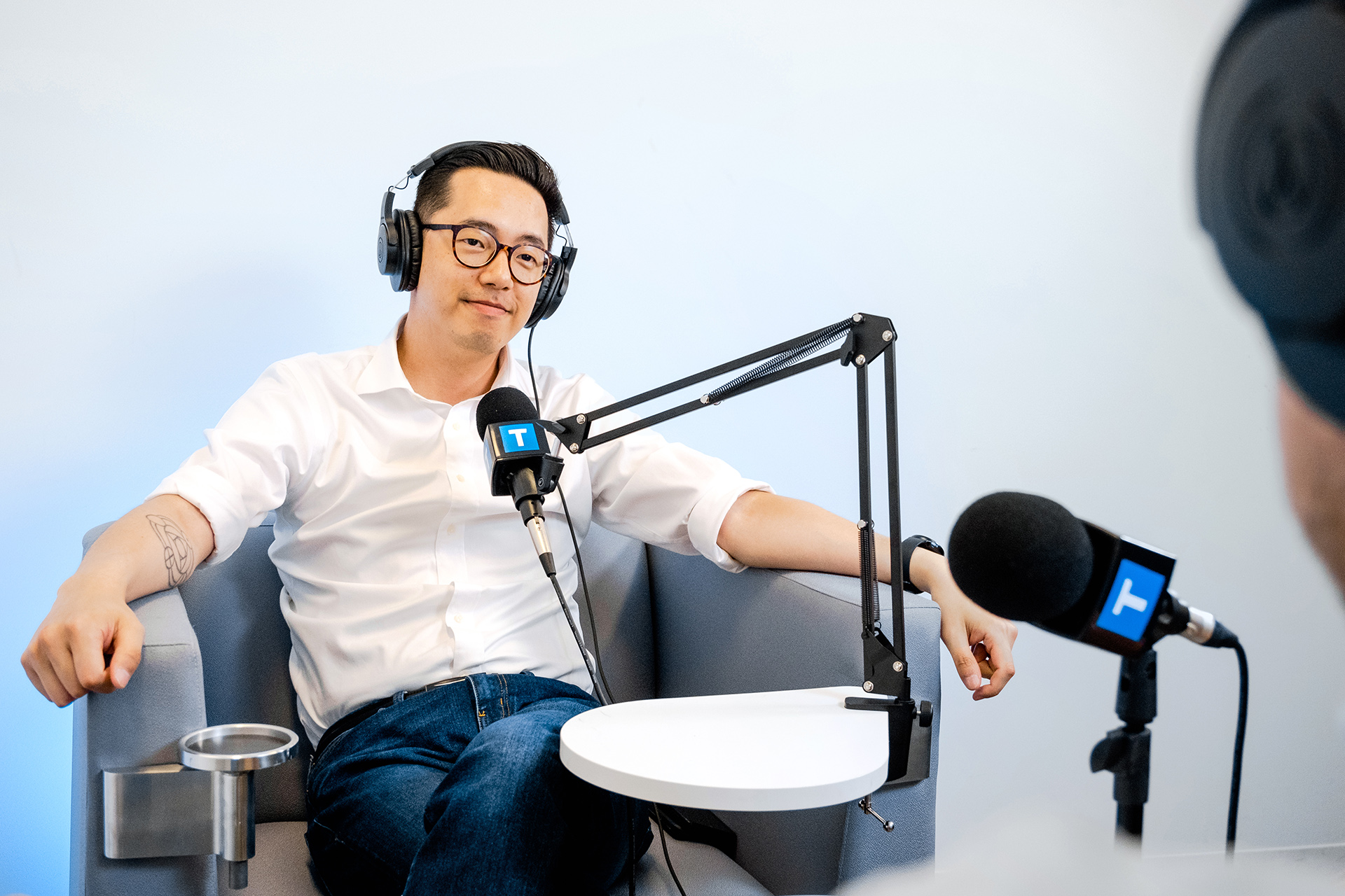 Jawn Jang interviews a person for the TransLink podcast