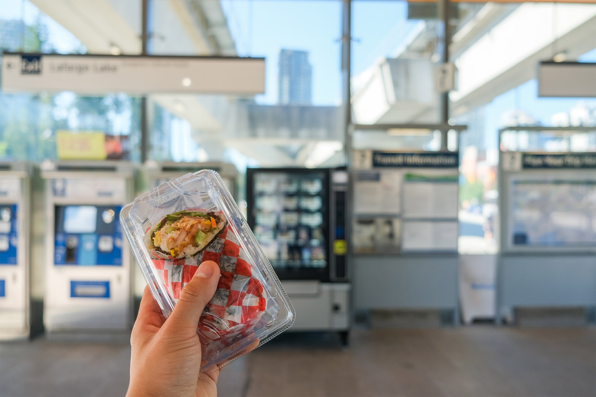 A sushi wrap in front of a vending machine at Lafarge Lake–Douglas Station
