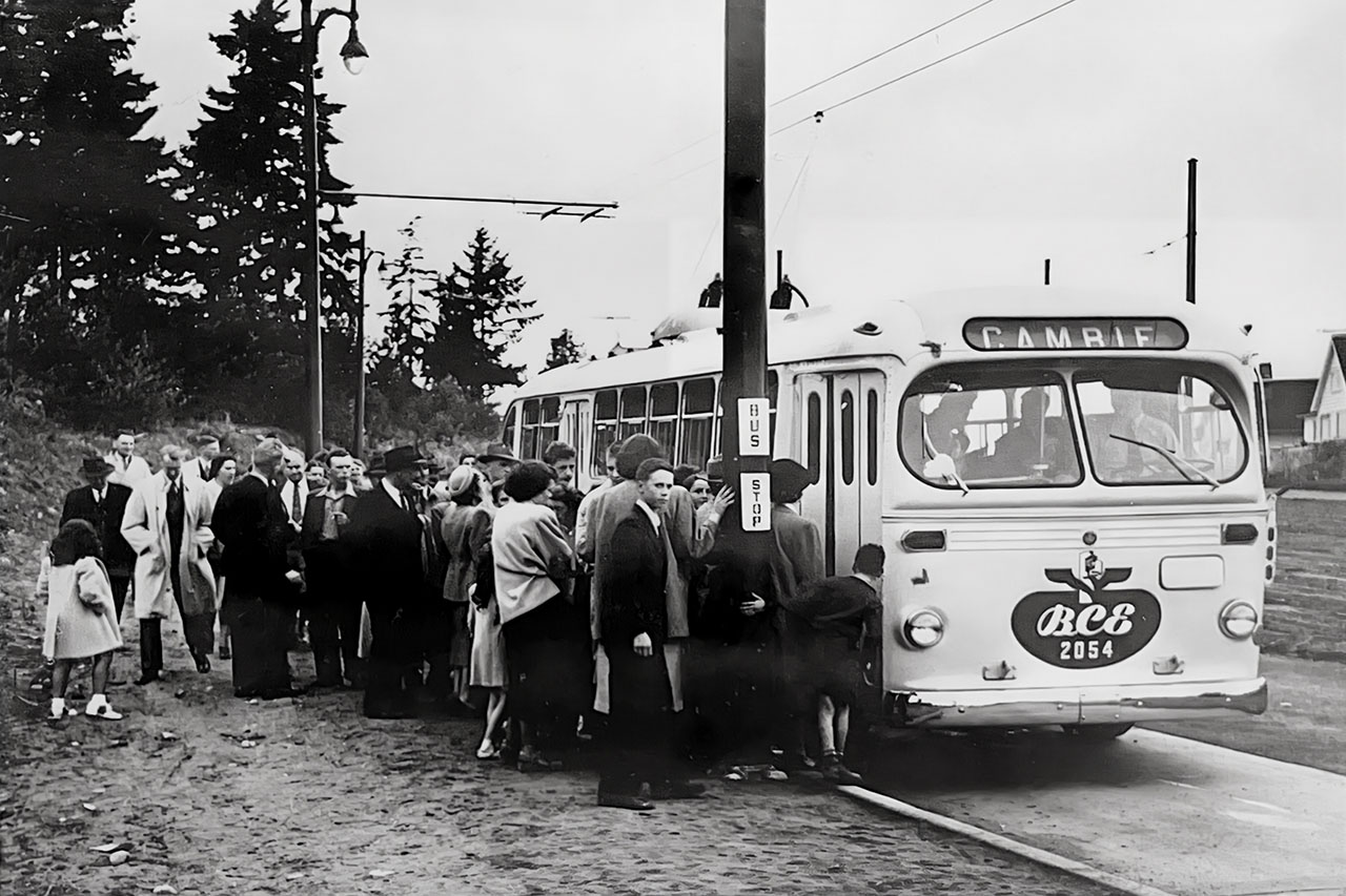 Passengers line up at Queen Elizabeth Park on Cambie St to board trolley coach 2054 on the first day of regular trolley service 1948