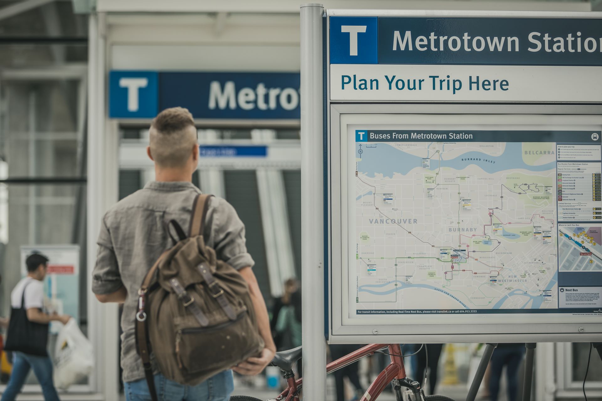 Customer looking at maps outside Metrotown Station for trip planning