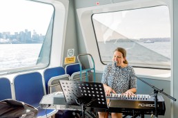Jill plays the piano and sings on the SeaBus