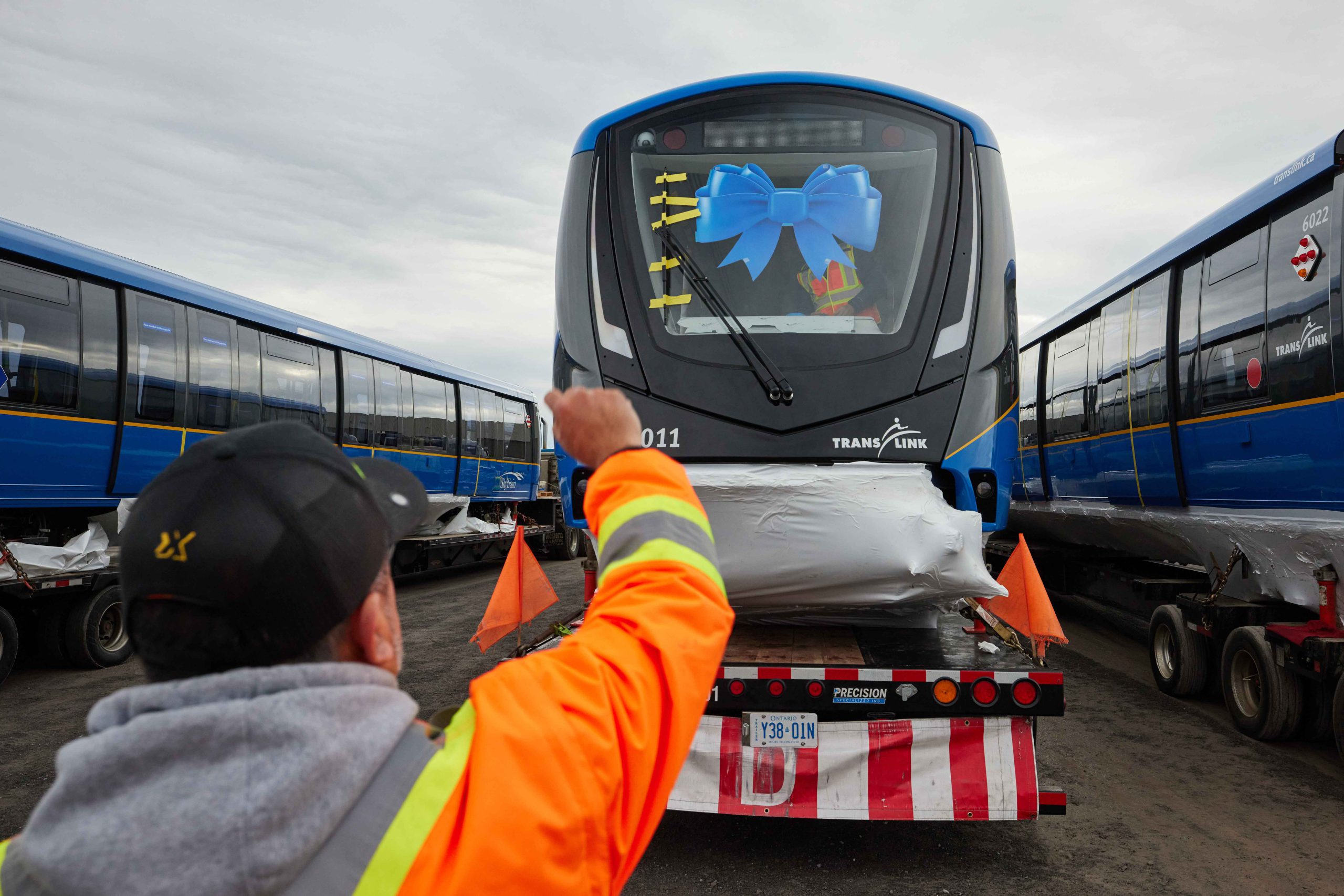 Loading the Mark V SkyTrain in Kingston, Ontario. Train wears a blue ribbon on its windshield.