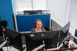 A Customer Information Work Leader at their desk