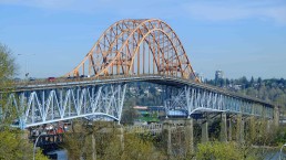 An orange bridge overlooks the Fraser River in British Columbia