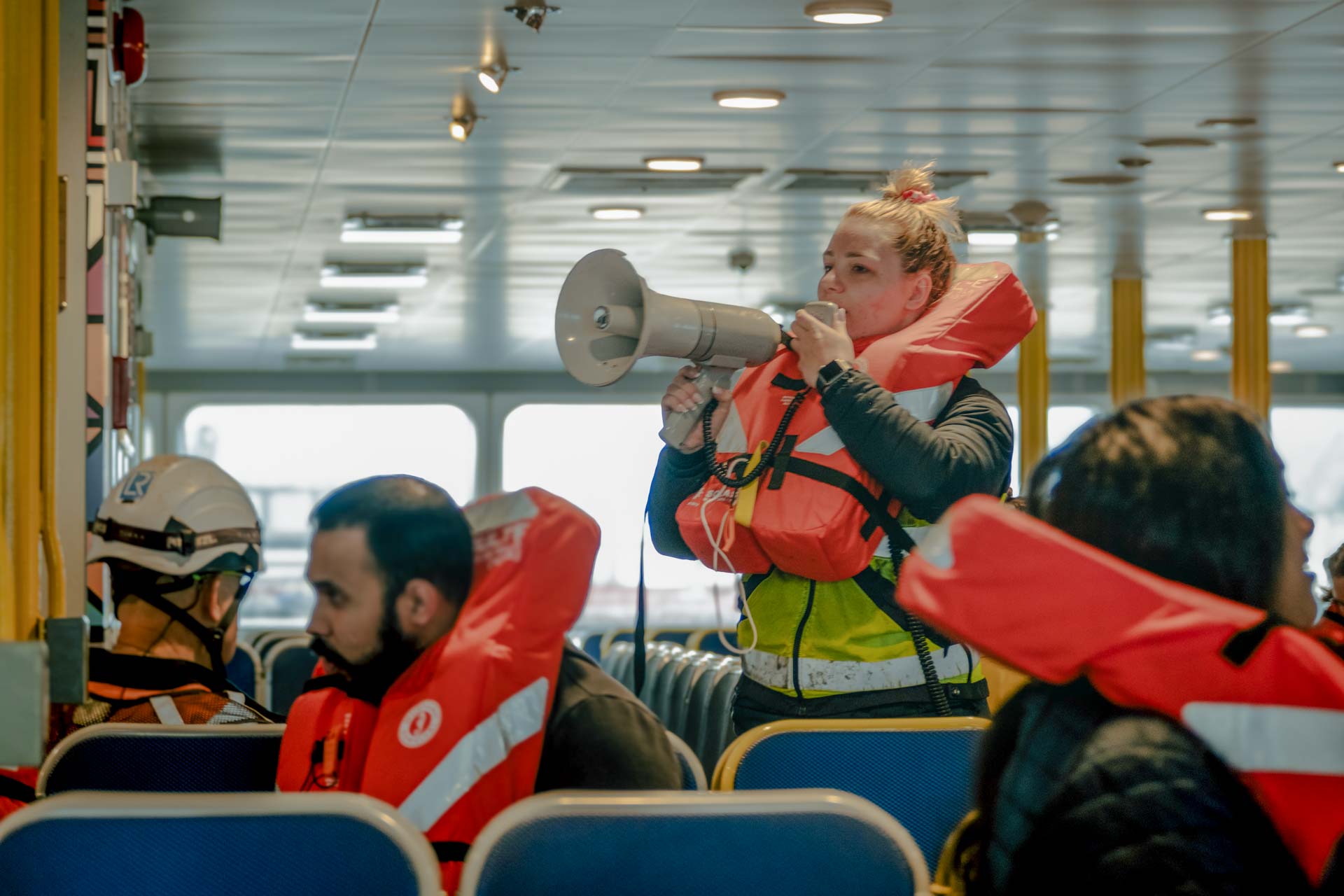 A SeaBus crew members makes an announcement to SeaBus passengers.