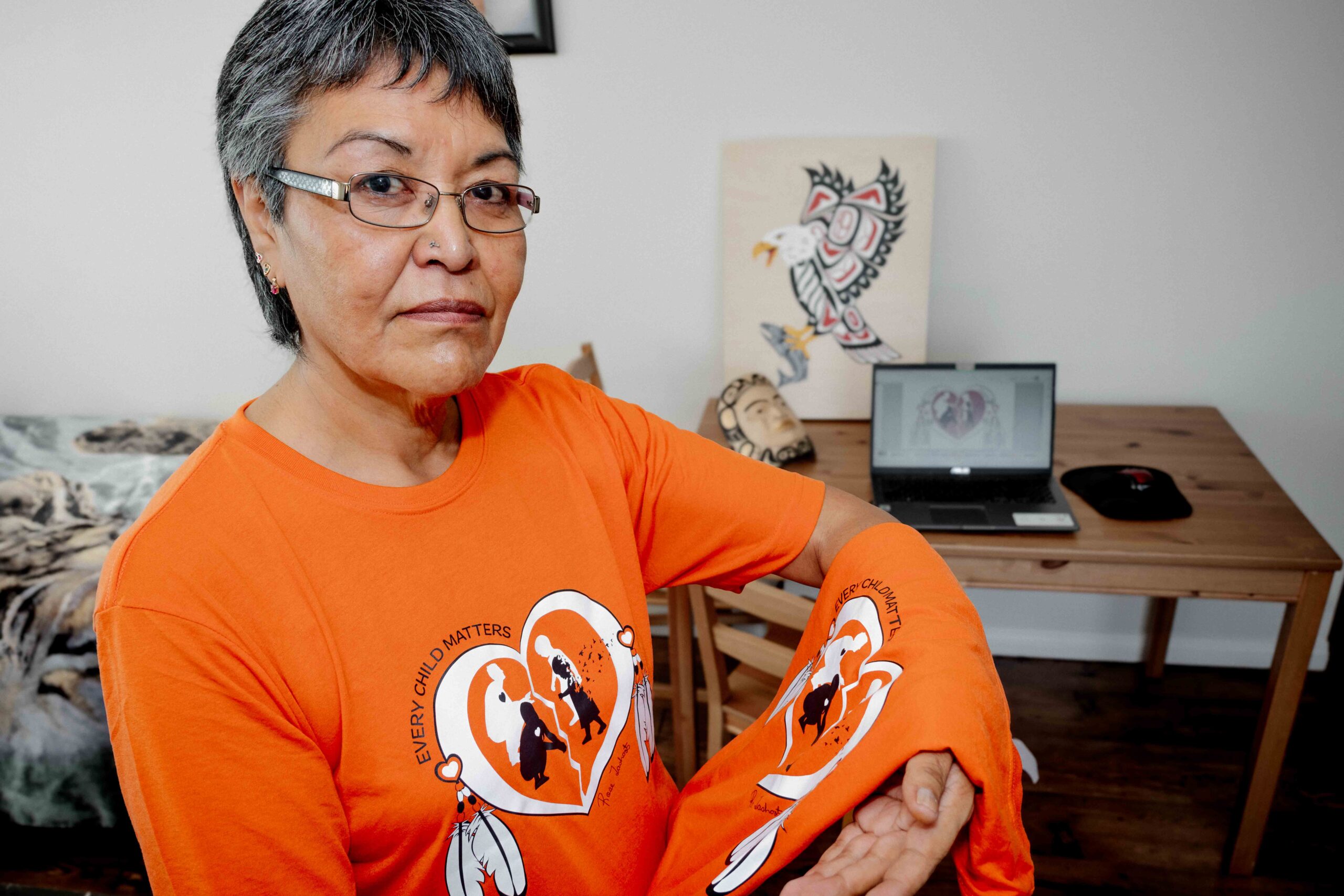 Rose Tashoots wears and holds her Orange Shirt Day shirt.