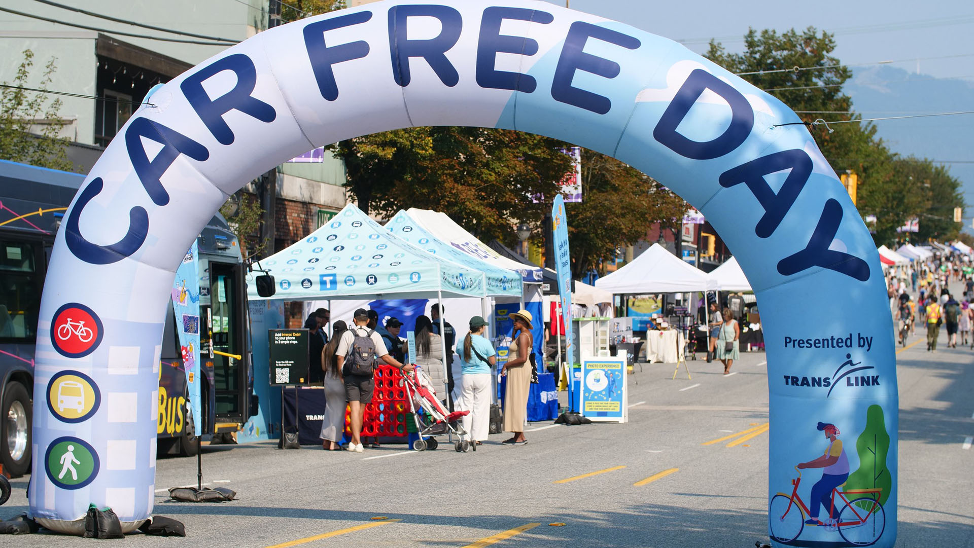 an inflatable arch banner says Car Free Day marking the entrance to Car Free Day Vancouver