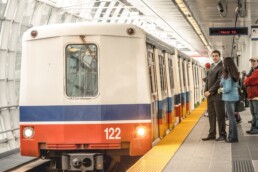 Customers wait for a SkyTrain Mark I train at Main Street–Science World