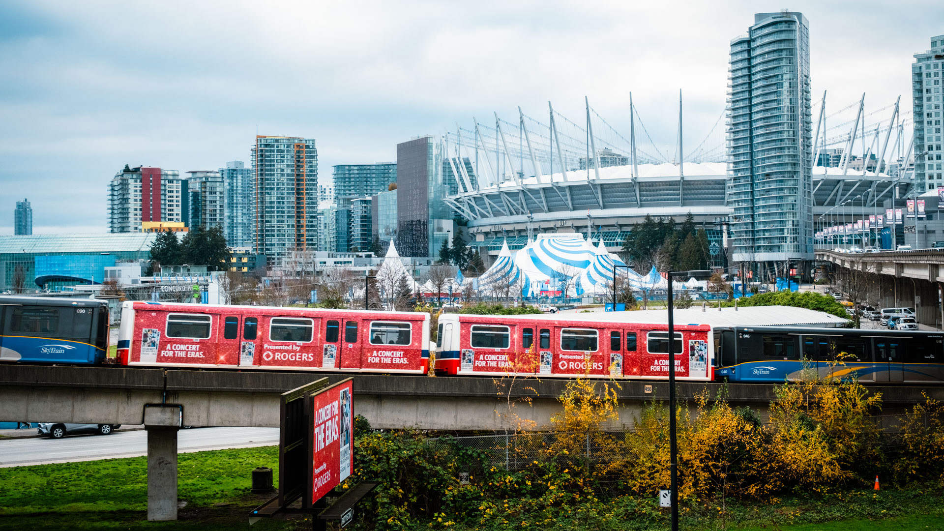 The SkyTrain passes by BC Place in the background