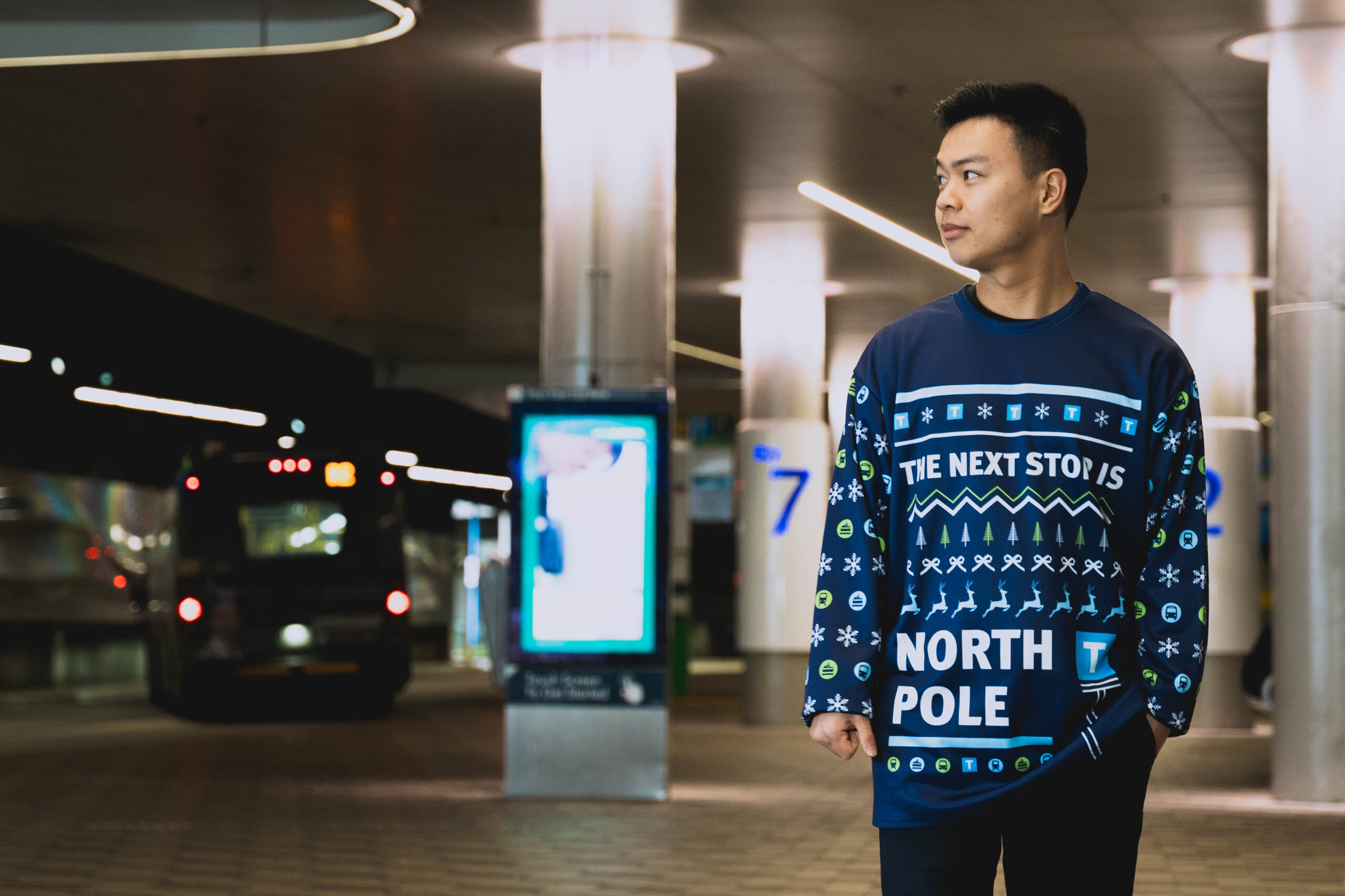 A man wears the new TransLink Store holiday merchandise pullover with North Pole design on it at Lonsdale Quay