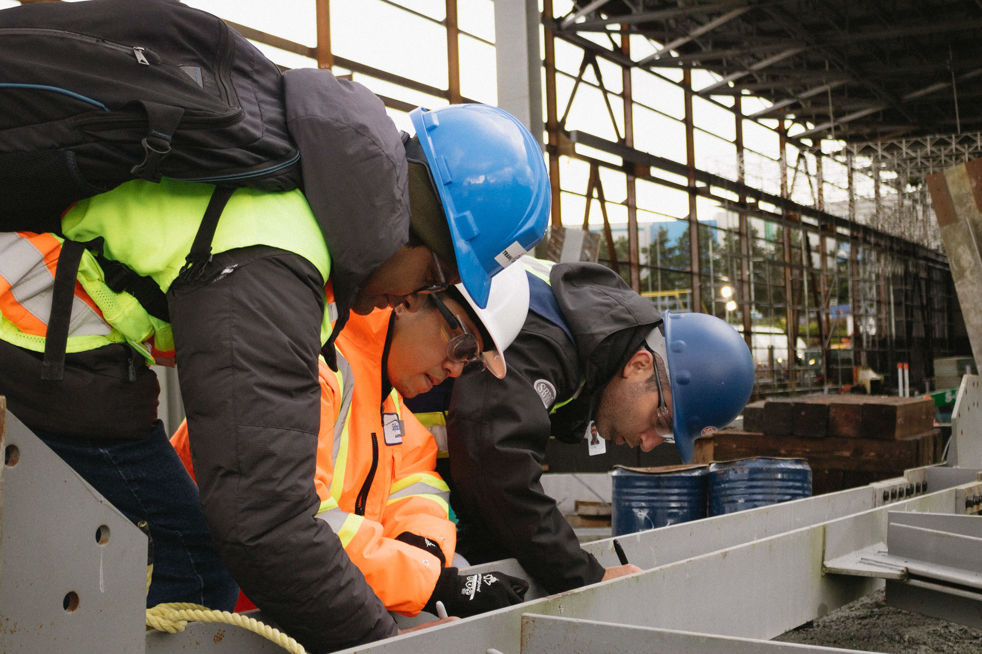 As part of a steel-topping tradition, staff sign the last steel beam before it's raised