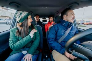 A group of four people inside a car