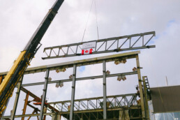 The final steel beam is placed atop the new maintenance centre's steel structure