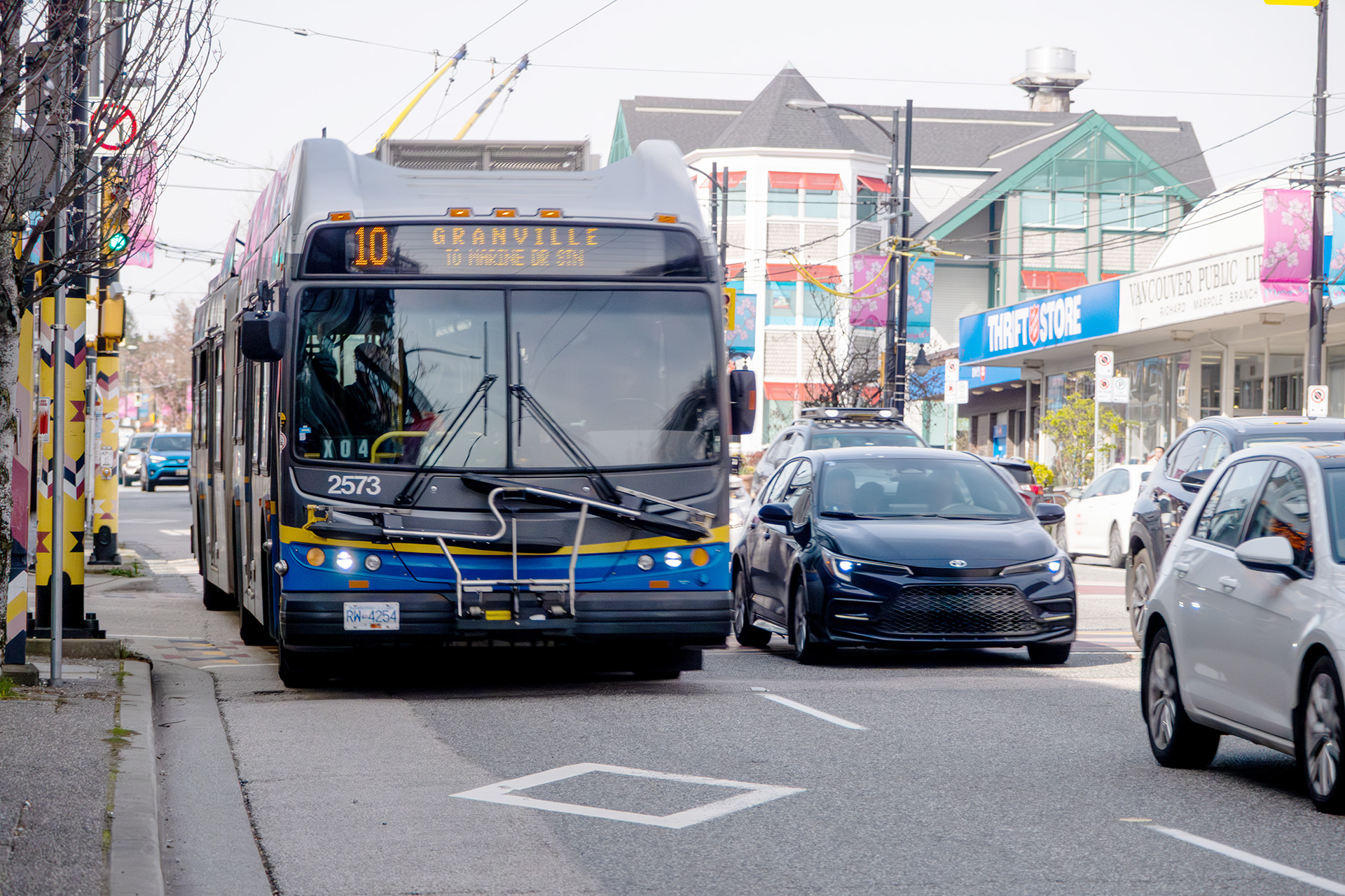 A 10 Granville bus travelling in a bus lane in the Marpole Village neighbourhood
