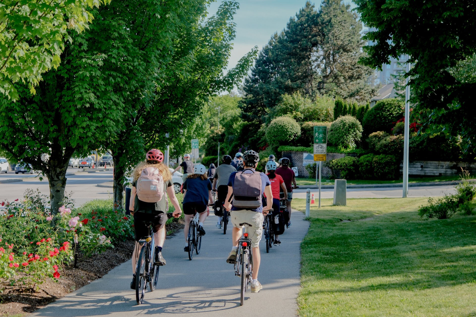 A group of people cycle on a multi-use path