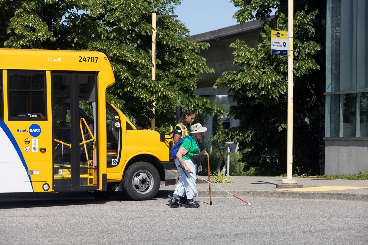 HandyDART customer walks with a HandyDART driver