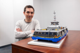 William poses beside his LEGO SeaBus creation