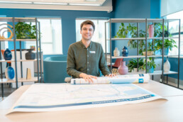 Kyle Monda rolling out transit maps onto a table