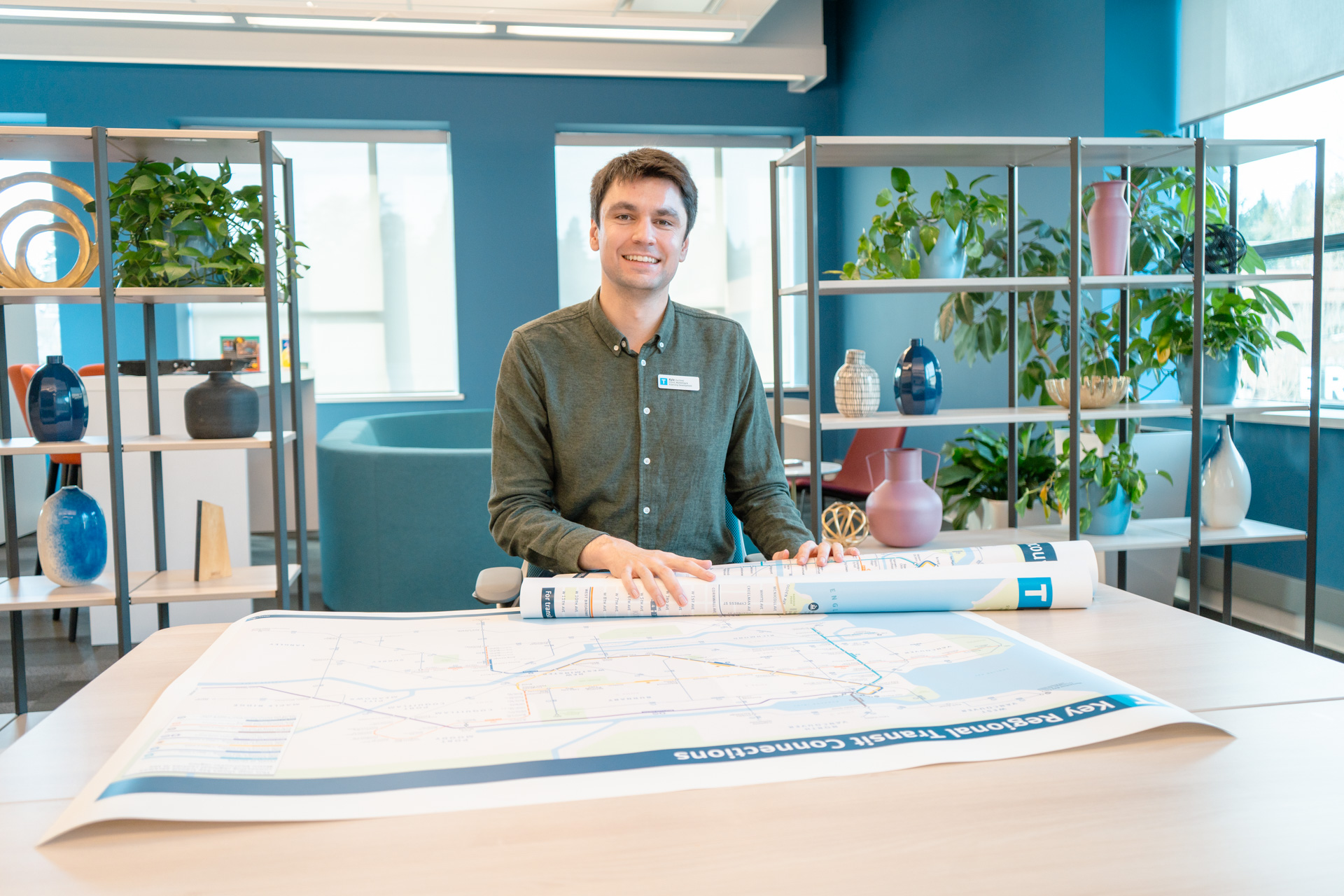 Kyle Monda rolling out transit maps onto a table