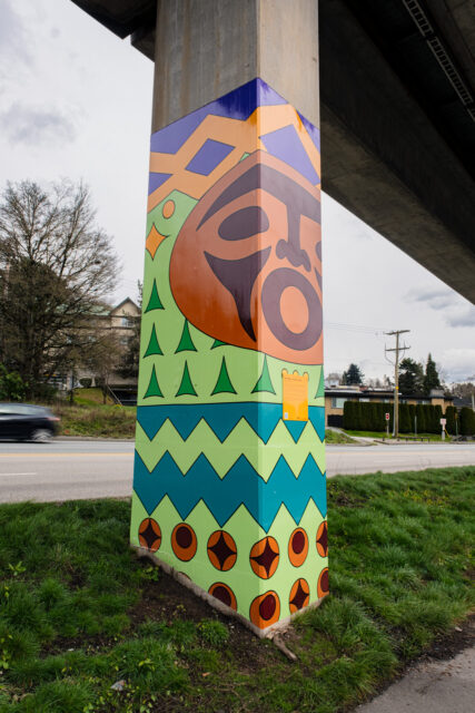 “Qwo’ Xwong :: Water Cry” by Roxanne Charles, a SkyTrain pillar artwork with Coast Salish‑inspired geometric patterns referencing water and land.