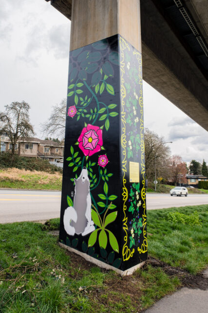 “Gifts of the Land” by Adele Arseneau, a SkyTrain pillar artwork showing beadwork‑inspired medicinal plants and wild roses along Stewardson Way.