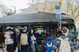 Transit riders board the 19 Kingsway to Metrotown Station bus at Main Street–Science World Station.