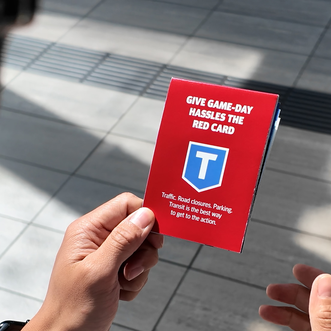 Hand holds TransLink's Red-yellow info card