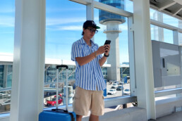 Person uses phone at YVR Vancouver International Airport