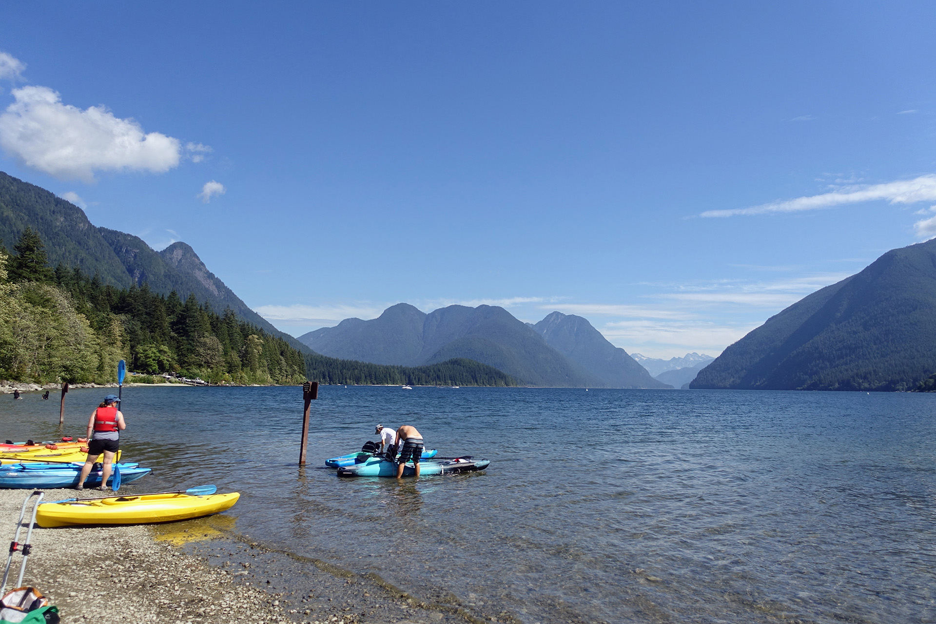 People enjoying beautiful Alouette Lake surrounded by mountains