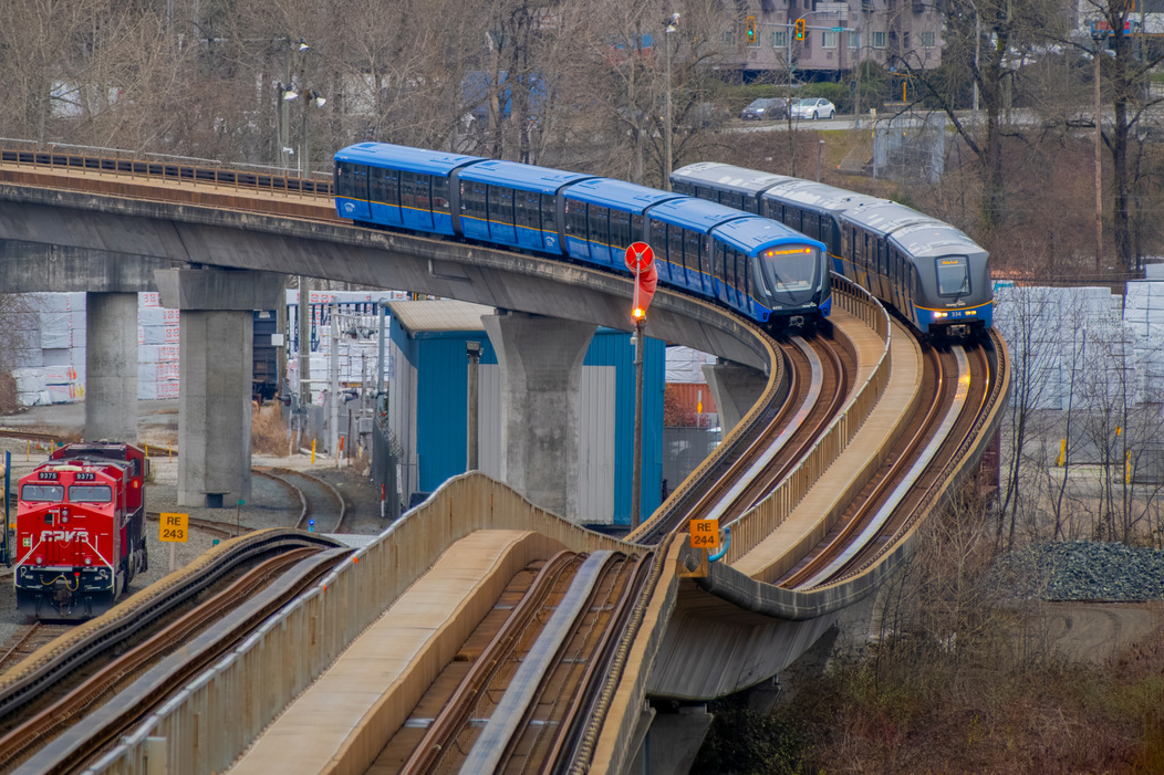 Two SkyTrain vehicles on the overhead guideway