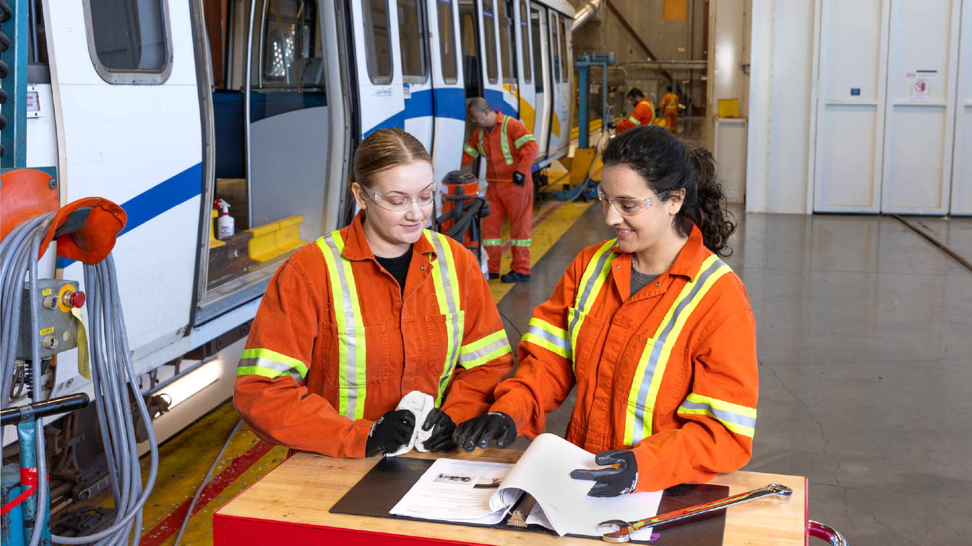 Two SkyTrain maintenance staff looking over a document